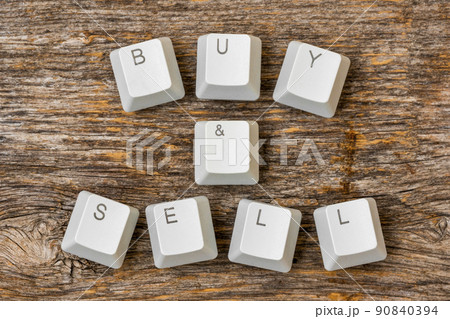 Computer keyboard keys arranged to spell BUY AND SELL words 90840394