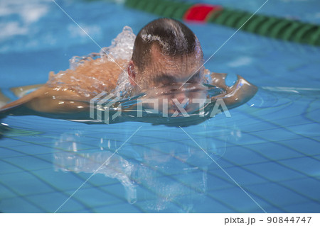 A man swims in the pool close-up. A man swims in the pool close-up. 90844747