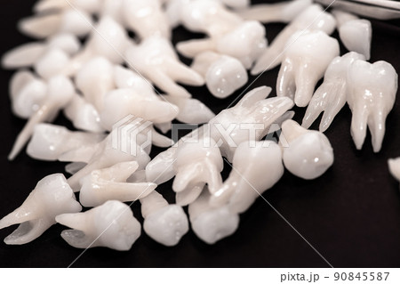 Teeth implant and crown installation process parts isolated on a blue background. Medically accurate 3D model. Teeth implant and crown installation process parts isolated on a blue background. Medically accurate 3D model. 90845587