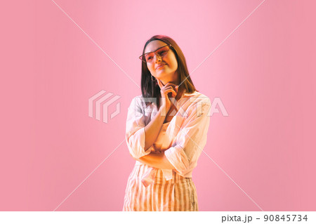 Studio shot of young pretty girl in summer fashion collection outfit posing isolated on pink background. Concept of emotions, facial expression, youth Studio shot of young pretty girl in summer fashion collection outfit posing isolated on pink background. Concept of emotions, facial expression, youth 90845734