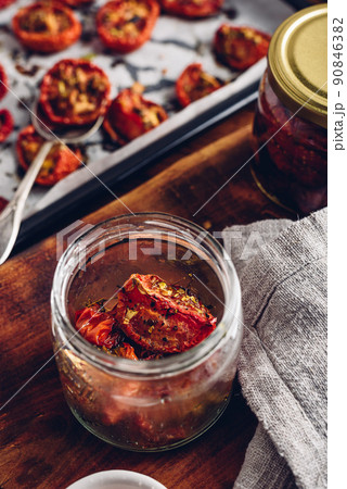 Prepared Sun Dried Tomatoes with Oil and Herbs in a Jar 90846382