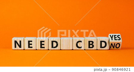 Need CBD, cannabidiol symbol. Turned a wooden cube and changed words 'need CBD no' to 'need CBD yes'. Beautiful orange background, copy space. Medical and need CBD cannabidiol concept. Need CBD, cannabidiol symbol. Turned a wooden cube and changed words 'need CBD no' to 'need CBD yes'. Beautiful orange background, copy space. Medical and need CBD cannabidiol concept. 90846921