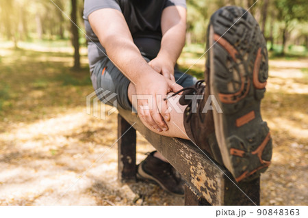 young man practising stretching exercises for the sports championship. athlete preparing for a marathon. health and wellness lifestyle. 90848363