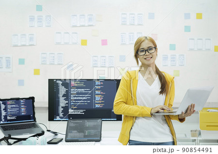 Young programmer or IT specialist satisfied with her work done. 90854491