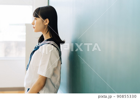 黒板の前に立つ女子高生 90855330
