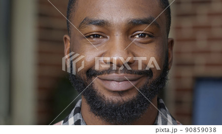 Portrait of young adult showing candid smile in front of camera, having white healthy teeth. Male model smiling and feeling happy, showing positive emotions and confident authentic expression. Portrait of young adult showing candid smile in front of camera, having white healthy teeth. Male model smiling and feeling happy, showing positive emotions and confident authentic expression. 90859038