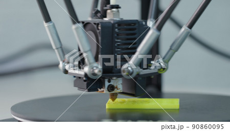 3D Printing Machine printing a piece of plastic 90860095