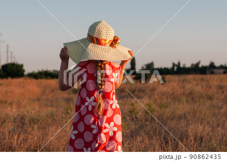 Child girl in straw hat dress in wheat field. Smiling kid in sunglasses sunset countryside. Cottagecore style aesthetic. Child girl in straw hat dress in wheat field. Smiling kid in sunglasses sunset countryside. Cottagecore style aesthetic. 90862435