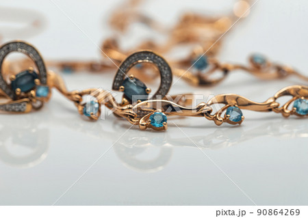 A gold chain with a pendant and a Topaz ring 90864269