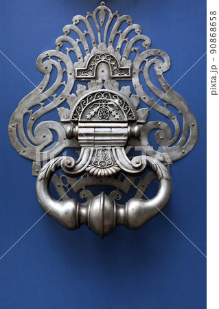 Close up of a mansion blue wooden door Close up of a mansion blue wooden door 90868658
