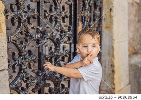 Adorable caucasian kid asking to be quiet with finger on lips. silence and secret concept 90868964