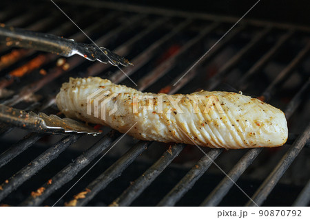 Fresh squid is being grilled on stove macro close up 90870792