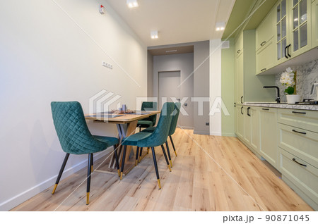 Modern light green luxurious kitchen with dining table 90871045