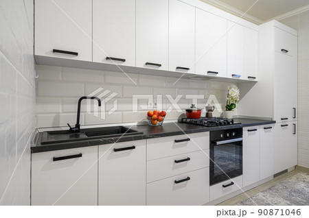 Trendy white modern kitchen interior with minimalistic furniture 90871046