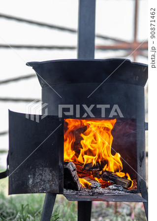 Cooking in cauldron on open fire in nature. 90871462