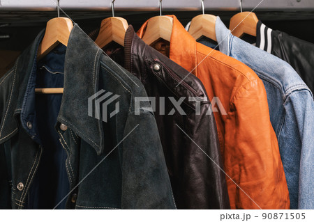 Various vintage jackets on clothing rack in second hand store 90871505