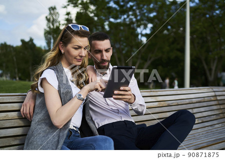 Millennial best friends discussing media content during online networking Millennial best friends discussing media content during online networking 90871875