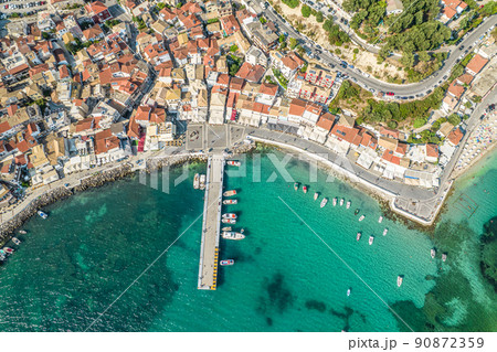 Beautiful colorful houses of seaside town, port of Parga with boats, cruise ship. Sand beach with umbrellas, tourist people, blue, turquoise sea water. Summer vacations and travel concept. Greece. 90872359