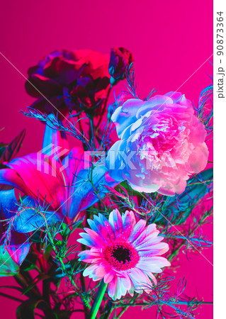 Beautiful bouquet of flowers, abstract floral composition in glass vase over pink, magenta background in neon light. Concept of floristry, decorations, creativity, decor 90873364