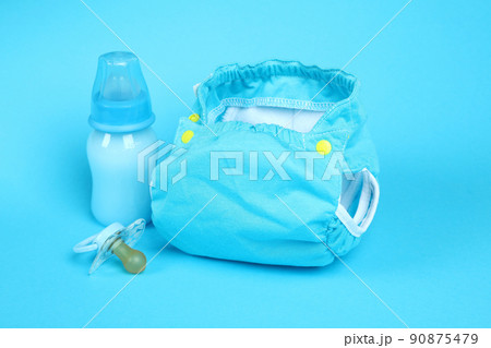 Concept of baby clothes with reusable diapers on blue background 90875479