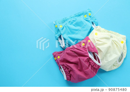 Reusable diapers on blue background, close up 90875480