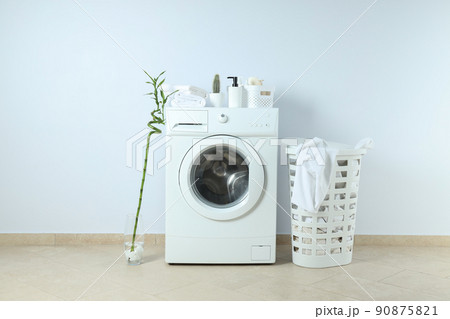 Concept of housework with washing machine against white wall Concept of housework with washing machine against white wall 90875821
