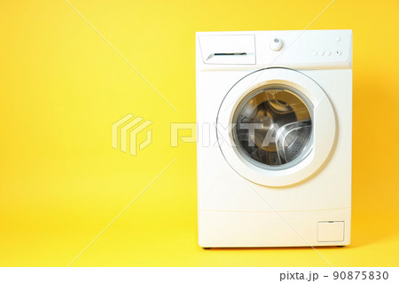 Modern white washing machine on yellow background 90875830