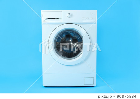 Modern white washing machine on blue background Modern white washing machine on blue background 90875834