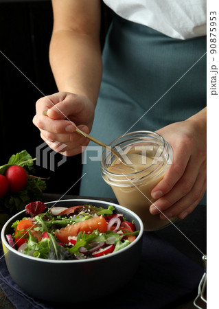 Concept of cooking vegetable salad with tahini sauce on dark textured table 90875953