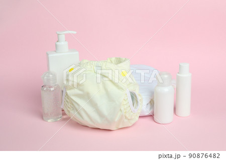 Concept of baby clothes with reusable diapers on pink background Concept of baby clothes with reusable diapers on pink background 90876482