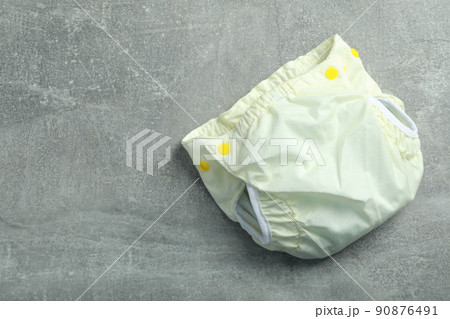Reusable diapers on gray textured background, close up Reusable diapers on gray textured background, close up 90876491