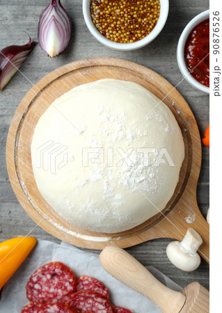 Concept of cooking pizza on gray wooden background Concept of cooking pizza on gray wooden background 90876526