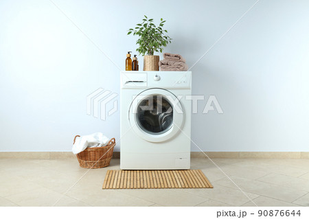 Concept of housework with washing machine against white wall 90876644