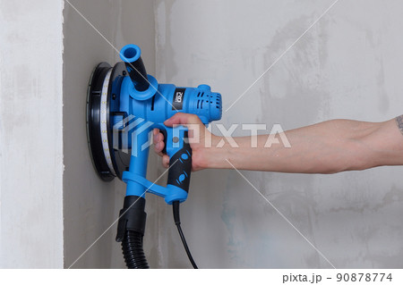 builders grind the walls with a grinder.construction works.renovation of the premises builders grind the walls with a grinder.construction works.renovation of the premises 90878774