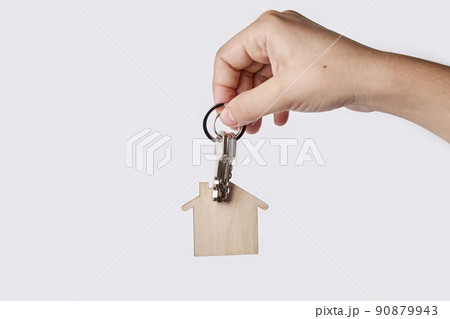 Hand is holding wooden house modelon white background. Concept for new home, property and estate. Hand is holding wooden house modelon white background. Concept for new home, property and estate. 90879943