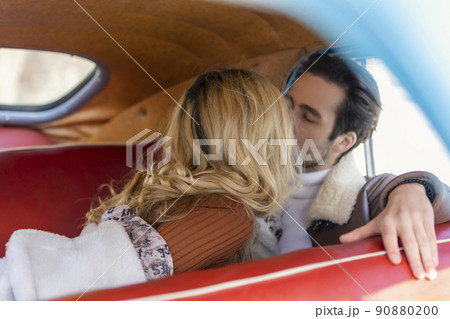 couple sitting in the back seat of a car couple sitting in the back seat of a car 90880200