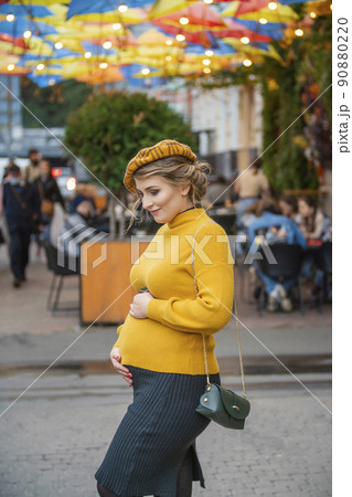 pregnant woman walking in the street 90880220