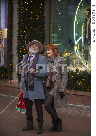 an elderly couple walking the streets of the city an elderly couple walking the streets of the city 90880241