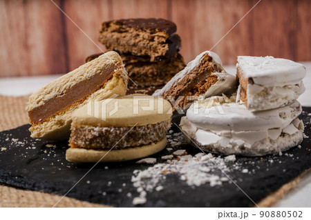 Three different types of the classic Argentinean alfajores filled with dulce de leche. Traditional food. 90880502