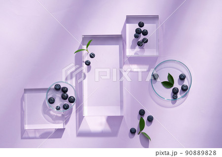 Top view of blueberry extract with transparent podium and blank space in purple background  90889828
