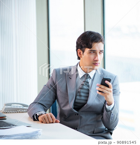 The young successful businessman working at the office The young successful businessman working at the office 90891545