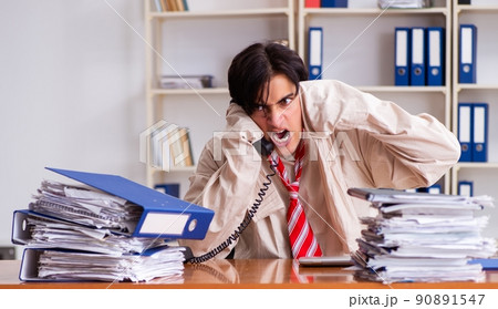Crazy young man in straitjacket at the office Crazy young man in straitjacket at the office 90891547