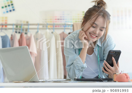 Young woman designer clothing, clothing designer workspace, clothing design accessories. 90891993