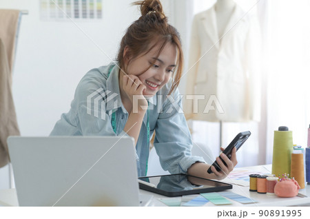 Young woman designer clothing, clothing designer workspace, clothing design accessories. 90891995