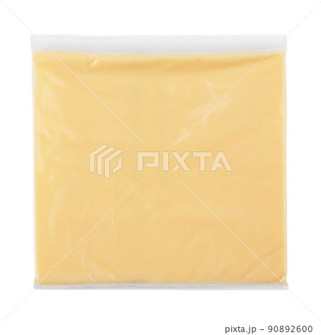 Single slice of processed cheese wrapped in clear transparency plastic package  90892600