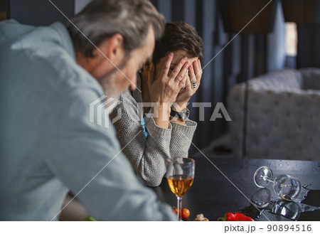aged couple in the kitchen talking about something 90894516