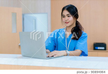 Woman Healthcare worker using laptop in hospital. 90894964