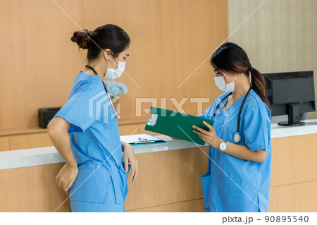 Female doctor stands at hospital. Healthcare worker.  90895540