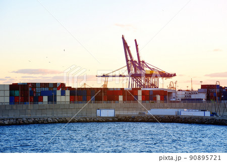 Container crane in seaport on sunset in La Marina de Valencia. Container crane in seaport on sunset in La Marina de Valencia. 90895721