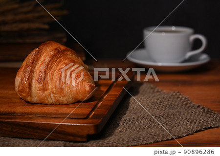 Fresh homemade butter croissant and coffee cup on wooden table. Breakfast, bread bakery products cafe concept 90896286